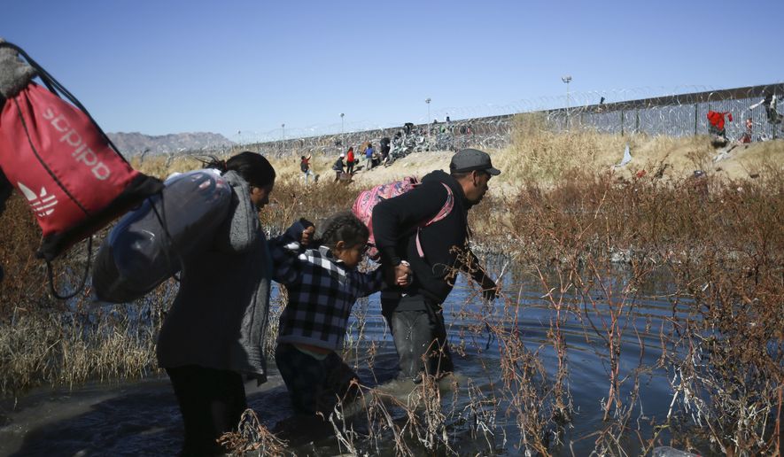 Migrants cross the Rio Grande river to reach the United States from Ciudad Juarez, Mexico, Wednesday, Dec. 27, 2023. (AP Photo/Christian Chavez)