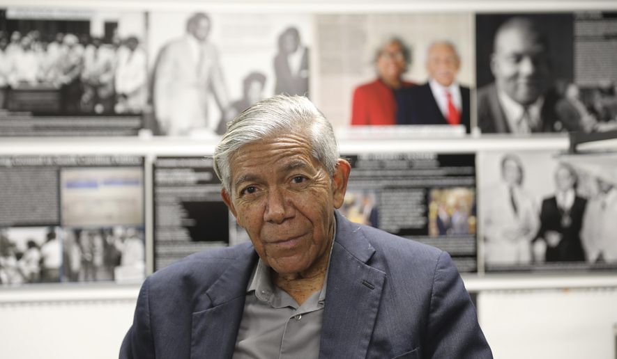 South Carolina civil rights photographer Cecil Williams sits in front of some of the displays he created for his museum, the only civil rights museum in the state, on Tuesday, Dec. 12, 2023, in Orangeburg, South Carolina. (AP Photo/Jeffrey Collins)