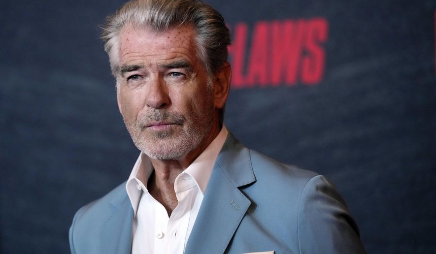 Pierce Brosnan, a cast member in &quot;The Out-Laws,&quot; poses at a special screening of the film, Monday, June 26, 2023, at the Regal LA Live theaters in Los Angeles. Brosnan has been in hot water plenty of times as an actor playing the secret agent James Bond, though not in Yellowstone National Park. Now, for allegedly stepping out of bounds in a thermal area during a recent visit, Brosnan faces two citations and a court date in the world&#x27;s oldest national park. (AP Photo/Chris Pizzello) **FILE**