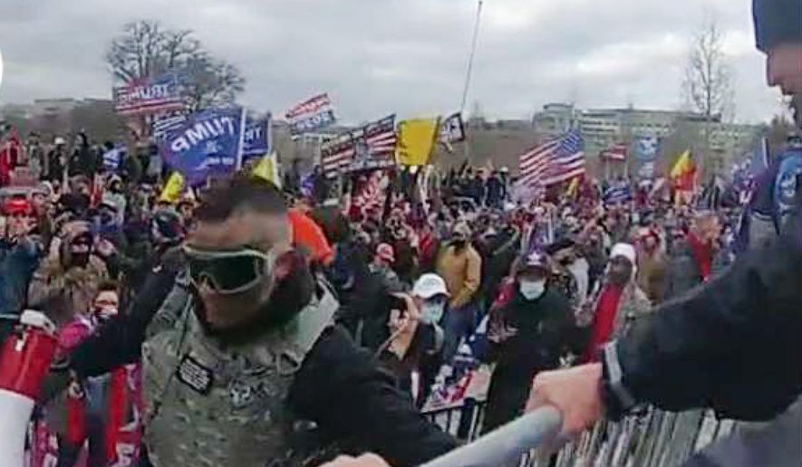 This image from video from a police-worn body camera provided by the Justice Department and contained in the statement of facts shows Samuel Lazar, bottom left, at the U.S. Capitol on Jan. 6, 2021, in Washington. Court documents unsealed this week say that a Pennsylvania man who was sentenced in secret for his role in the U.S. Capitol riot cooperated with authorities investigating the Jan. 6, 2021, attack and an unrelated case. The documents provide insight into the unusual secrecy regarding Samuel Lazar, who was released from federal custody in September after completing his sentence in his Capitol riot case. (Justice Department via AP)