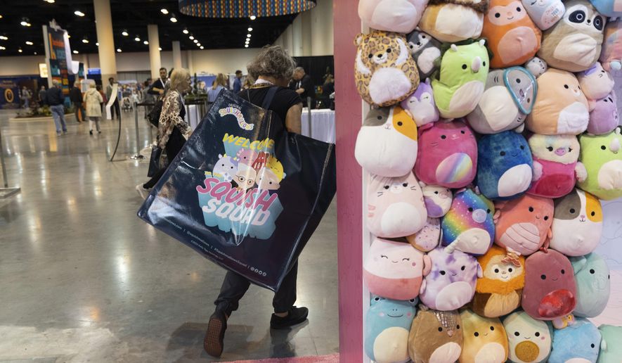 A shareholder leaves the Squishmallows booth with a large bag of purchases in the exhibition hall of the Berkshire Hathaway annual meeting on Saturday, May 6, 2023, in Omaha, Neb. A judge in New York has ruled that Alibaba must face a lawsuit by a U.S. toymaker alleging that the Chinese ecommerce giant’s online platforms were used to sell counterfeit Squishmallows. (AP Photo/Rebecca S. Gratz, File)
