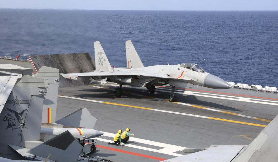In this photo released by Xinhua News Agency, a J-15 Chinese fighter jet prepares to take off from the Shandong aircraft carrier during the combat readiness patrol and military exercises around the Taiwan Island by the Eastern Theater Command of the Chinese People&#x27;s Liberation Army (PLA) on Sunday, April 9, 2023. Weeks before Taiwan holds elections for its president and legislature, China has renewed its threat to use military force to annex the self-governing island democracy it claims as its own territory. (An Ni/Xinhua via AP, File)