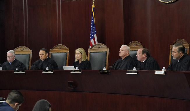 Arizona Supreme Court Justices from left; William G. Montgomery, John R Lopez IV, Vice Chief Justice Ann A. Scott Timmer, Chief Justice Robert M. Brutinel, Clint Bolick and James Beene listen to oral arguments on April 20, 2021, in Phoenix. (AP Photo/Matt York, File)