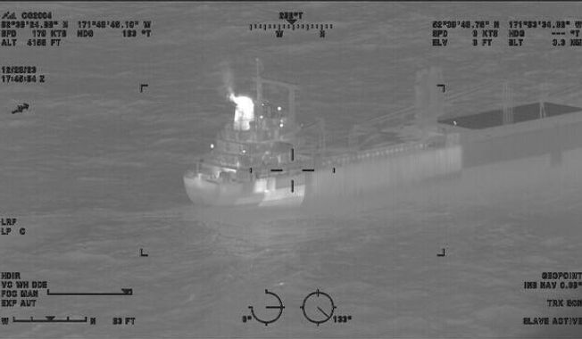 This image provided by the U.S. Coast Guard shows a reported fire aboard the 410-foot cargo vessel Genius Star XI, approximately 200 miles southwest of Dutch Harbor, Alaska on Thursday, Dec. 29, 2023. The large cargo ship with a fire in its hold is being kept 2 miles (3.22 kilometers) offshore of an Alaska port as a precaution while efforts are undertaken to extinguish the flames, the U.S. Coast Guard said Saturday. (Lt.Cmdr. Michael Salerno/U.S. Coast Guard via AP)