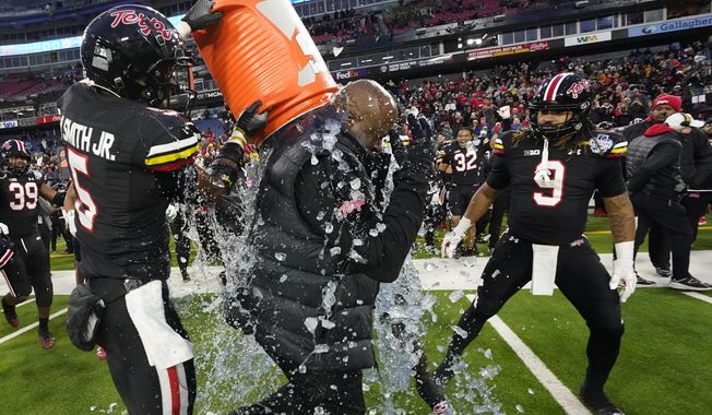 Maryland wide receiver Octavian Smith Jr., left, douses head coach Mike Locksley with Gatorade after winning the Music City Bowl NCAA college football game 31-13 against Auburn Saturday, Dec. 30, 2023, in Nashville, Tenn. (AP Photo/George Walker IV)