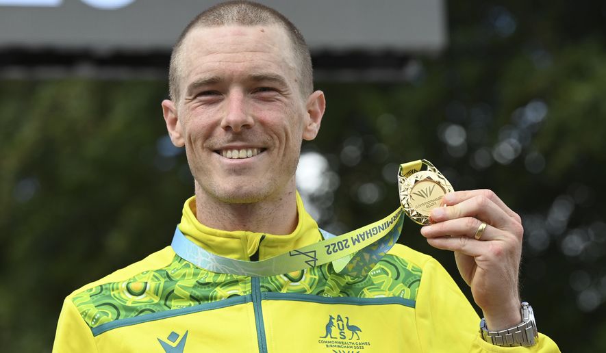 Gold medal winner Rohan Dennis of Australia poses with his medal after the men&#x27;s cycling individual time trials at the Commonwealth Games in West Park, Wolverhampton, England, on Aug. 4, 2022. Dennis was reported to have been charged in connection with the death of his wife, Olympic cyclist Melissa Hoskins, who died after being struck by a vehicle while riding in Adelaide. (AP Photo/Rui Vieira, File)
