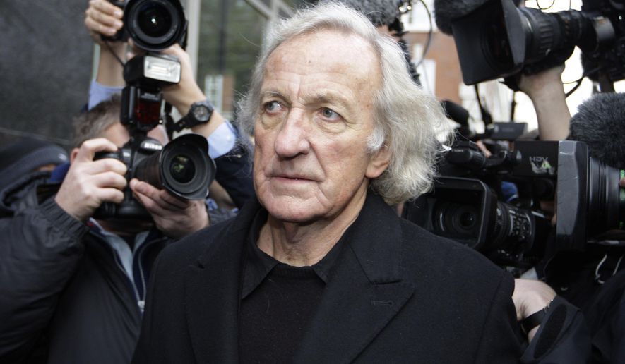 Journalist John Pilger, a supporter of Wikileaks founder Julian Assange arrives at the City of Westminster Magistrates Court in London where Julian Assange is in court for his bail hearing, Tuesday, Dec. 14, 2010. John Pilger, the Australia-born journalist and documentary maker known for his coverage of the Khmer Rouge in Cambodia, has died. He was 84. (AP Photo/Sang Tan, File)