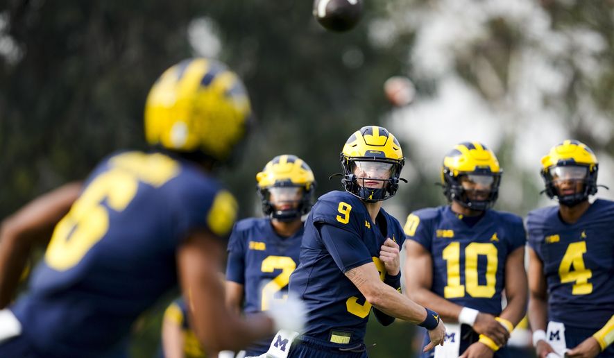 Michigan quarterback J.J. McCarthy (9) throws to wide receiver Cornelius Johnson (6) during practice Friday, Dec. 29, 2023, in Carson, Calif. Michigan is scheduled to play against Alabama on New Year&#x27;s Day in the Rose Bowl, a semifinal in the College Football Playoff. (AP Photo/Ryan Sun)