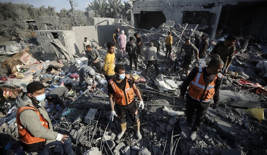 Palestinians inspect the damage of a destroyed house following Israeli airstrikes on Khan Younis, Southern Gaza Strip, Sunday, Dec. 31, 2023. (AP Photo/Mohammed Dahman)