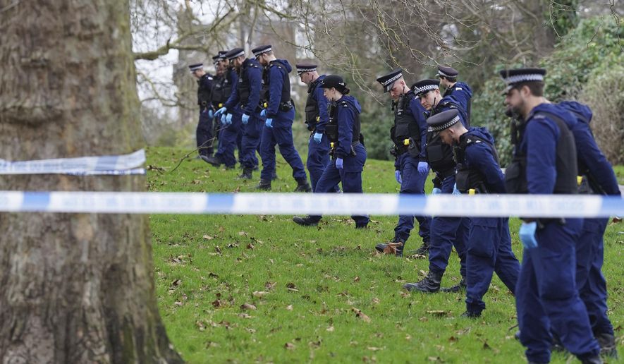 Police officers conduct a fingertip search on Primrose Hill where a teenage boy died after being stabbed just before midnight on New Year's Eve, in London, Monday, Jan. 1, 2024. A 16-year-old boy was stabbed to death on a hill overlooking central London as crowds gathered to watch New Year's Eve fireworks. Police say that Harry Pitman died on Primrose Hill just before midnight. A boy the same age was arrested on suspicion of murder and was being held in custody Monday. (Stefan Rousseau/PA via AP)