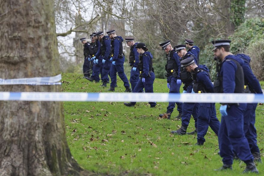 Police officers conduct a fingertip search on Primrose Hill where a teenage boy died after being stabbed just before midnight on New Year's Eve, in London, Monday, Jan. 1, 2024. A 16-year-old boy was stabbed to death on a hill overlooking central London as crowds gathered to watch New Year's Eve fireworks. Police say that Harry Pitman died on Primrose Hill just before midnight. A boy the same age was arrested on suspicion of murder and was being held in custody Monday. (Stefan Rousseau/PA via AP)