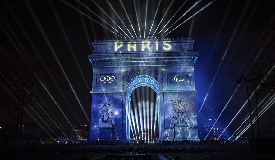 A light show is projected on the Arc de Triomphe during New Year celebrations on the Champs Elysees in Paris, France, Monday, Jan. 1, 2024, (AP Photo/Aurelien Morissard)