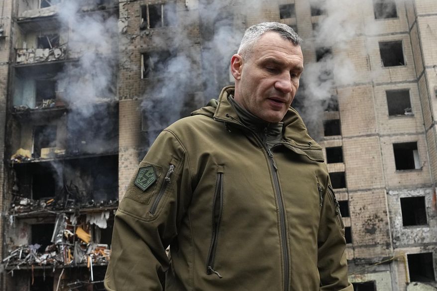Mayor of Kyiv Vitali Klitschko inspects damages as smoke rises out from a destroyed apartment building after a Russian attack in Kyiv, Ukraine, Tuesday, Jan. 2, 2024. (AP Photo/Efrem Lukatsky) ** FILE **