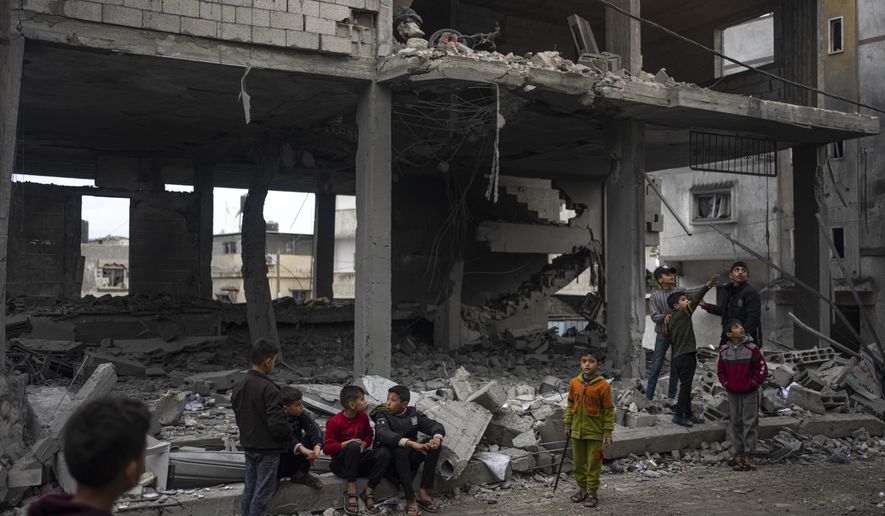 Palestinians look at the destruction after an Israeli strike in Rafah, southern Gaza Strip, Wednesday, Jan. 3, 2024. (AP Photo/Fatima Shbair) **FILE**