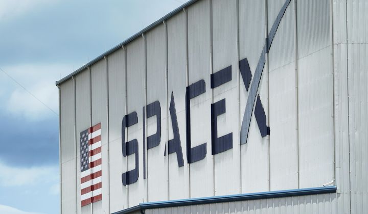 The SpaceX logo is displayed on a building, May 26, 2020, at the Kennedy Space Center in Cape Canaveral, Fla. On Wednesday, Jan. 3, 2024, a U.S. labor agency accused SpaceX of unlawfully firing employees who penned an open letter critical of CEO Elon Musk and creating an impression that worker activities were under surveillance by the rocket ship company. (AP Photo/David J. Phillip, File)