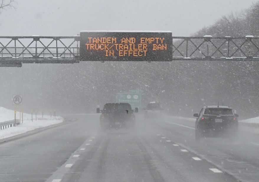 FILE - A roadway caution sign is seen on the New York Thruway as motorists commute during a winter snow storm, March 14, 2023, in Albany, N.Y. A winter weather system moving through the U.S. is expected to wallop the East Coast this weekend, Saturday, Jan. 6, 2024, into Sunday, Jan. 7, with a mix of snow and freezing rain from the southern Appalachians to the Northeast — although it's too early to say exactly which areas will get what precipitation and how much. (AP Photo/Hans Pennink, File)
