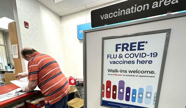 A sign for flu and covid vaccinations is displayed at a pharmacy store in Palatine, Ill., Wednesday, Sept. 13, 2023. The flu season in the U.S. is getting worse but it&#x27;s too soon to tell how much holiday gatherings contributed to a likely spike in illnesses. New government data posted Friday, Jan. 5, 2024 for the previous week _ the holiday week between Christmas and New Year&#x27;s _ show 38 states with high or very high levels for respiratory illnesses with fever, cough and other symptoms. That&#x27;s up from 31 states the week before. (AP Photo/Nam Y. Huh)