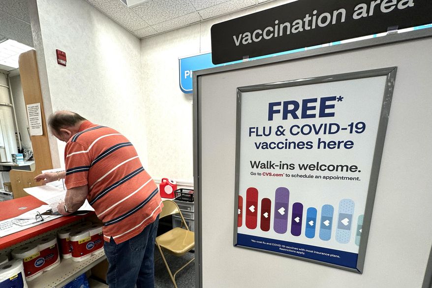 A sign for flu and covid vaccinations is displayed at a pharmacy store in Palatine, Ill., Wednesday, Sept. 13, 2023. The flu season in the U.S. is getting worse but it's too soon to tell how much holiday gatherings contributed to a likely spike in illnesses. New government data posted Friday, Jan. 5, 2024 for the previous week _ the holiday week between Christmas and New Year's _ show 38 states with high or very high levels for respiratory illnesses with fever, cough and other symptoms. That's up from 31 states the week before. (AP Photo/Nam Y. Huh)