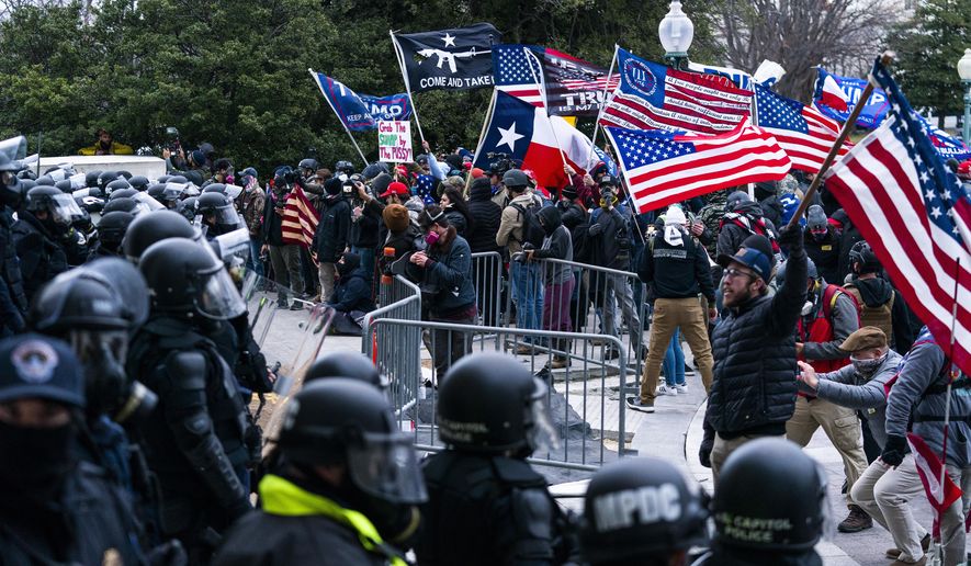 Supporters of President Donald Trump are confronted by U.S. Capitol Police officers outside the Capitol, Wednesday, Jan. 6, 2021, in Washington. The FBI arrested three Florida residents on Saturday, Jan. 6, 2024, the third anniversary of their alleged attack on Capitol police officers during the Jan. 6, 2021, insurrection. (AP Photo/Manuel Balce Ceneta, File)