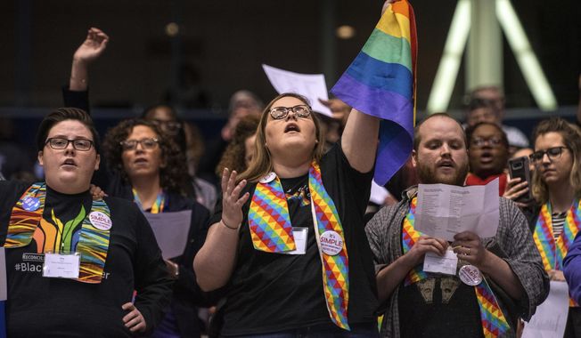 Shelby Ruch-Teegarden, center, of Garrett-Evangelical Theological Seminary, joins other protestors during the United Methodist Church&#x27;s special session of the general conference in St. Louis, in this Tuesday, Feb. 26, 2019, file photo. Disagreements over LGBTQ policies have splintered the Methodists in the years since. (AP Photo/Sid Hastings, File)
