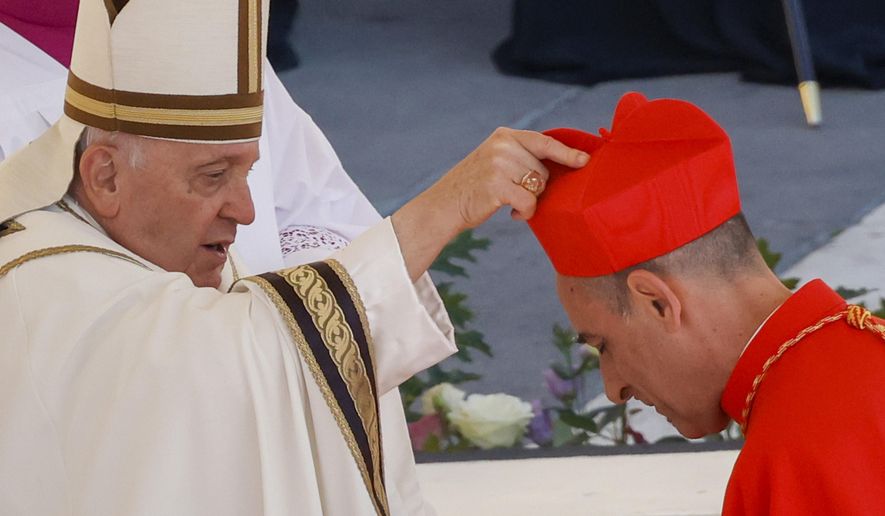 Newly elected Cardinal Víctor Manuel Fernández, Prefect of the Dicastery for the Doctrine of the Faith, right, receives his biretta from Pope Francis as he is elevated in St. Peter's Square at The Vatican, Saturday, Sept. 30, 2023. The Vatican’s new doctrine chief, already under fire from entire bishops conferences for his approval of blessings for same-sex couples, is raising eyebrows anew over a book he wrote as a young priest describing orgasms in graphic terms. (AP Photo/Riccardo De Luca, File)