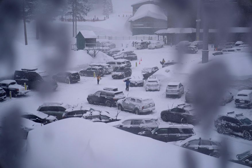 People through the parking area of the Alpine Base Area at Palisades Tahoe during a winter storm Friday, Feb. 24, 2023, in Alpine Meadows, Calif. Search teams were deployed following an avalanche Wednesday at the Palisades ski resort near Lake Tahoe, officials said. (AP Photo/John Locher, File)