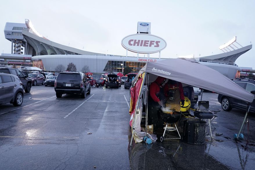 Fans tailgate outside of Arrowhead Stadium before an NFL wild-card playoff football game between the Kansas City Chiefs and the Miami Dolphins Saturday, Jan. 13, 2024, in Kansas City, Mo. (AP Photo/Charlie Riedel)