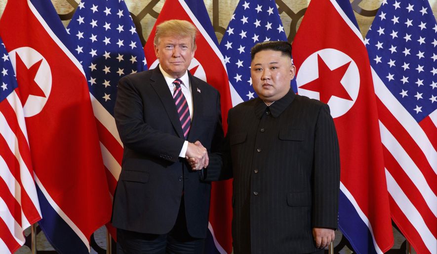 U.S. President Donald Trump, left, poses with North Korean leader Kim Jong-un for a photo in Hanoi, Vietnam, on Feb. 27, 2019. (AP Photo/Evan Vucci, File)
