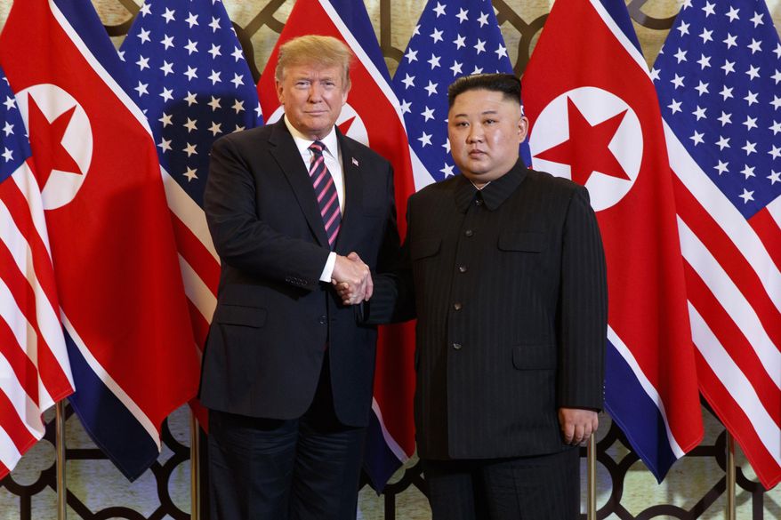 U.S. President Donald Trump, left, poses with North Korean leader Kim Jong-un for a photo in Hanoi, Vietnam, on Feb. 27, 2019. (AP Photo/Evan Vucci, File)