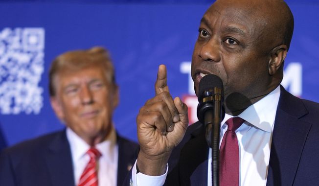 Sen. Tim Scott, R-S.C., speaks as Republican presidential candidate former President Donald Trump listens at a campaign event in Concord, N.H., Friday, Jan. 19, 2024. (AP Photo/Matt Rourke)