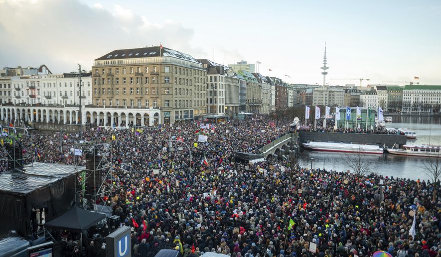 Demonstrators protest against the right-wing extremist activities as they gather in the Jungfernstieg and surrounding areas in Hamburg, Germany, Friday Jan. 19, 2024. (Jonas Walzberg/dpa via AP)