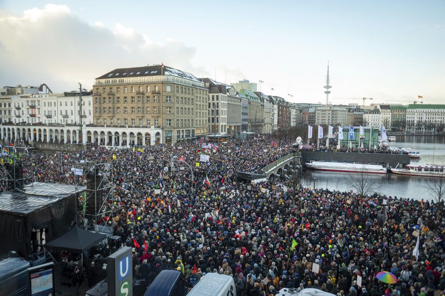 Demonstrators protest against the right-wing extremist activities as they gather in the Jungfernstieg and surrounding areas in Hamburg, Germany, Friday Jan. 19, 2024. (Jonas Walzberg/dpa via AP)