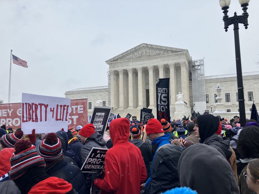 Thousands of pro-life activists braved snow and below-freezing temperatures to protest legalized abortion in the nation’s capital on Friday, walking to the Capitol and Supreme Court. (Sean Salai/The Washington Times)