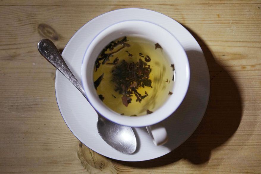 A cup of black tea with a spoon and tea leaves in London, on Aug. 29, 2022. An American scientist has sparked a trans-Atlantic tempest in a teapot by offering Britain advice on its favorite hot beverage. Bryn Mawr College chemistry professor Michelle Francl says one of the keys to a perfect cuppa is a pinch of salt. The advice is included in Francl’s book “Steeped: The Chemistry of Tea,” published Wednesday by the Royal Society of Chemistry. (AP Photo/Alastair Grant) **FILE**