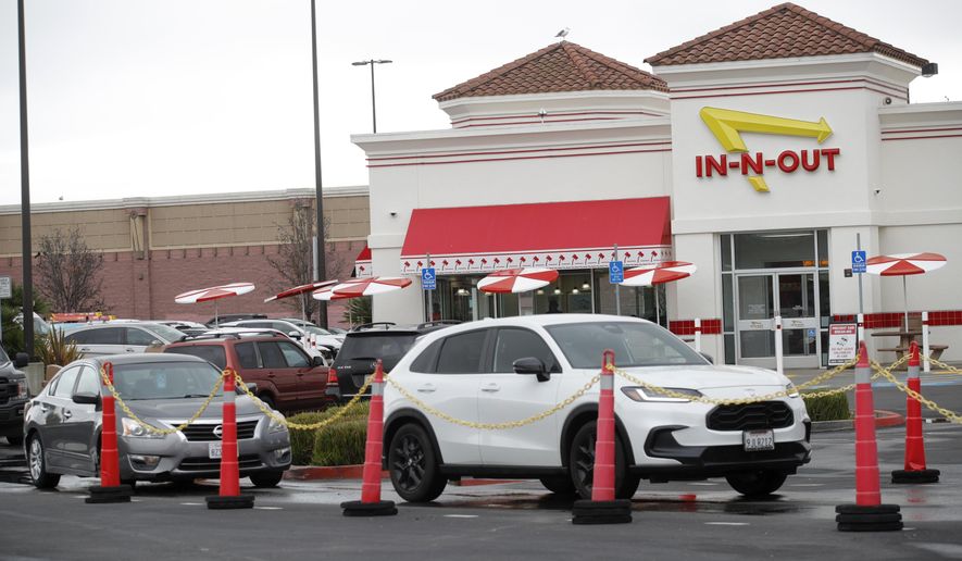 Customers line up at the In-N-Out drive-thru off Hegenberger Road in Oakland, Calif., on Monday, Jan. 22, 2024. In-N-Out will close its only restaurant in Oakland because of a wave of car break-ins, property damage, theft and armed robberies targeting customers and employees alike, the company announced. The burger joint in a busy corridor near the Oakland International Airport will close on March 24, 2024. (Jane Tyska/Bay Area News Group via AP)