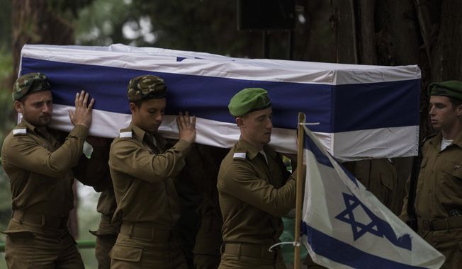 Israeli soldiers carry the flag-draped casket of reservist Sgt. first class Nicholas Berger during his funeral at Mt. Herzl military cemetery in Jerusalem, Israel, Wednesday, Jan. 24, 2024. Berger, 22, was killed during Israel&#x27;s ground operation in the Gaza Strip, where the Israeli army has been battling Palestinian militants in the war ignited by Hamas&#x27; Oct. 7 attack into Israel. (AP Photo/Leo Correa)