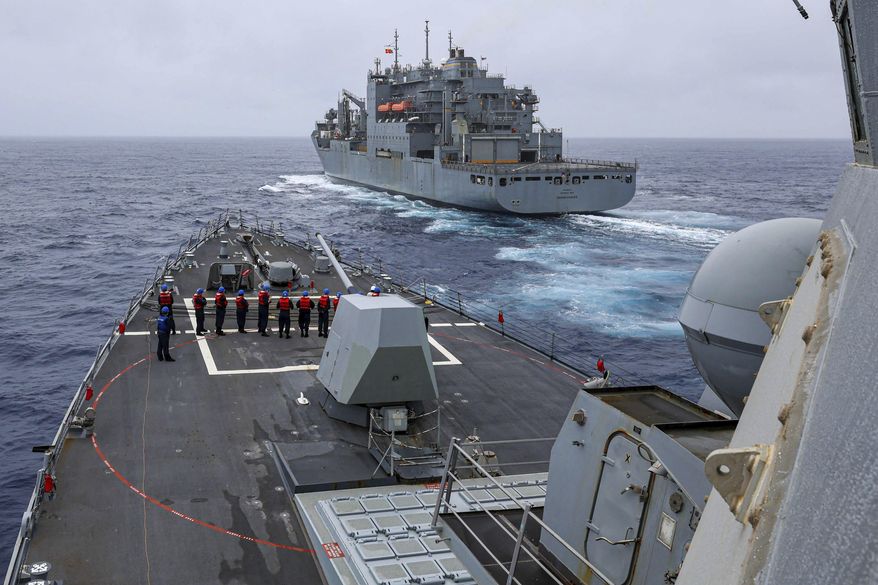 In this photo released by the U.S. Navy The Arleigh Burke-class guided-missile destroyer USS John Finn (DDG 113) prepares to come alongside Lewis and Clark-class dry cargo ship Cesar Chavez (T-AKE-14) in the East China Sea, on Jan. 21, 2024. China has accused the U.S. of abusing international law with its military maneuvers in the western Pacific, one day after the American naval destroyer sailed through the politically sensitive Taiwan Strait. (Mass Communication Specialist 2nd Class Justin Stack/U.S. Navy via AP)