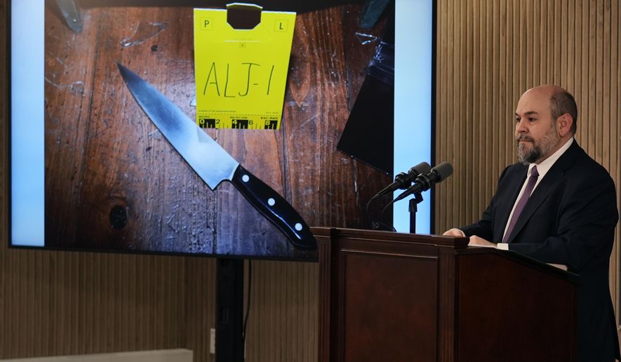 New Hampshire Senior Assistant Attorney General Ben Agati shows an evidence photograph of a large knife, while sharing findings of a deadly force shooting by Guilford, N.H. police on Jan. 1, 2023, during a news conference at the New Hampshire Department of Justice building, Thursday, Jan. 25, 2024, in Concord, N.H. According to a report released, police use of deadly force to shoot a teenager with mental health issues at his home after he approached officers carrying a knife was justified, New Hampshire's attorney general said Thursday. (AP Photo/Charles Krupa)