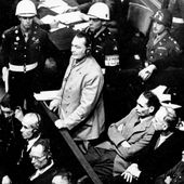 In this Nov. 21, 1945, file photo, Reichsmarshal Hermann Goering stands in the prisoner&#x27;s dock at the Nuremberg War Crimes Trial in Germany. He is entering a plea of not guilty to the International Military Tribunal Indictment. Goering is wearing headphones of the court translating system. Germany marks the 75th anniversary of the landmark Nuremberg trials of several Nazi leaders and in what is now seen as the birthplace of a new era of international law on Friday, Nov. 20, 2020. (AP Photo) **FILE**