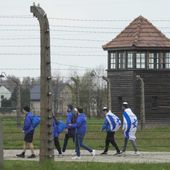 FILE - Jewish people visit the Auschwitz Nazi concentration camp after the March of the Living annual observance, in Oswiecim, Poland, April 28, 2022. Israel&#x27;s national Holocaust memorial has criticized a new agreement renewing Israeli school trips to Poland, saying it recommends a number of &quot;problematic sites&quot; that distort history. (AP Photo/Czarek Sokolowski, File)