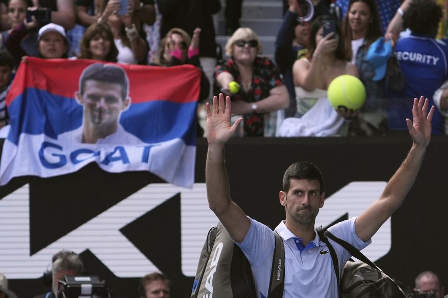 Novak Djokovic of Serbia gestures to the crowd as he leaves Rod Laver Arena following his loss to Jannik Sinner of Italy in their semifinal at the Australian Open tennis championships at Melbourne Park, Melbourne, Australia, Friday, Jan. 26, 2024. (AP Photo/Andy Wong)