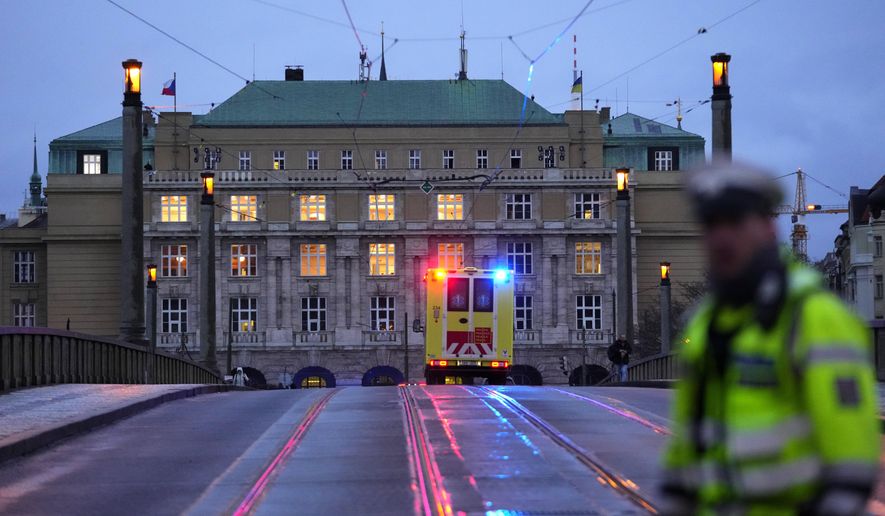 FILE - A police officer guards a street in downtown Prague, Czech Republic, on Dec. 21, 2023. Czech police say a shooting in downtown Prague has killed an unspecified number of people and wounded others. On Friday Jan. 26, 2024, the lower house of Czech Parliament approved an amendment to the country's gun law that tightens conditions to obtain weapons. (AP Photo/Petr David Josek/File)