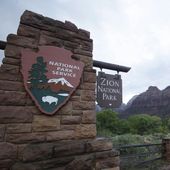 A sign hangs at Zion National Park on Tuesday, Sept. 15, 2015, near Springdale, Utah. A hiker has died of a suspected heart attack in Utah&#x27;s Zion National Park. The National Park Service said the man was found unresponsive on the West Rim Trail near Scout Lookout on Friday, Jan. 27, 2024. (AP Photo/Rick Bowmer, File)