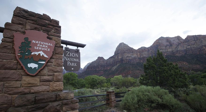 A sign hangs at Zion National Park on Tuesday, Sept. 15, 2015, near Springdale, Utah. A hiker has died of a suspected heart attack in Utah's Zion National Park. The National Park Service said the man was found unresponsive on the West Rim Trail near Scout Lookout on Friday, Jan. 27, 2024. (AP Photo/Rick Bowmer, File)