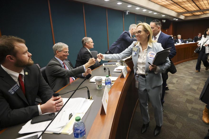 Rep. Esther Panitch, D-Sandy Springs, right, fist bumps Sen. Ben Watson, R-Savannah, a member of the Senate Judiciary Committee, after House Bill 30, an antisemitism bill, was passed unanimously by the Senate Judiciary Committee in the Coverdell Legislative Office Building, Jan. 22, 2024, in Atlanta. A handful of U.S. states are considering measures that would define antisemitism, but there's debate over whether they would stifle criticism of Israel. (Jason Getz/Atlanta Journal-Constitution via AP, file)