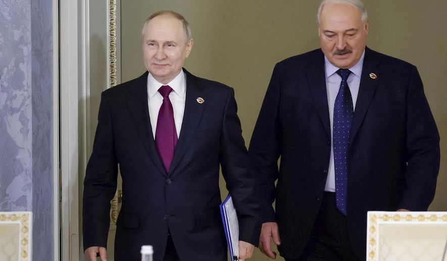 Russian President Vladimir Putin, left, and Belarus President Alexander Lukashenko arrive to attend a meeting of the Union State Supreme Council in St. Petersburg, Russia, Monday, Jan. 29, 2024. (Dmitry Astakhov, Sputnik, Government Pool Photo via AP)