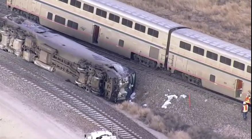 Emergency responders look over an Amtrak train derailment on Tuesday, Jan. 30, 2024, near Keenesburg, Colo. (KMGH via AP)