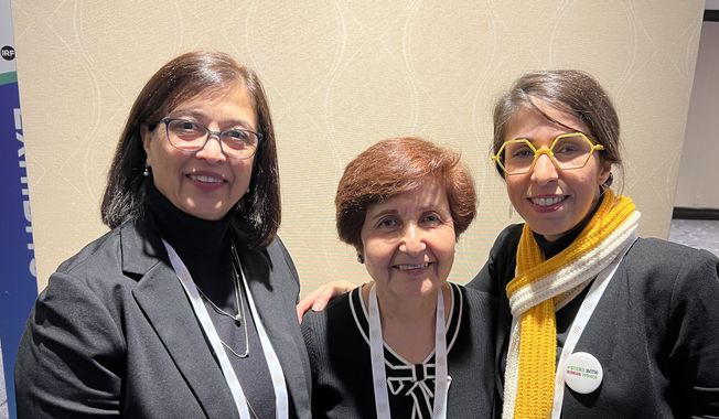 Minoo Anvari, at left, and Ruhi Jahanpour, center, members of the Baha’i faith, were each imprisoned in Shiraz, Iran, in 1982. Years later, Mitra Aliabouzar, jailed in Tehran’s Evin prison, was inspired by the example of Baha’i prisoners there, even though she is a nonbeliever. The women shared their experiences at the International Religious Freedom Summit 2024 in Washington, D.C. (Photo by Mark A. Kellner/The Washington Times) ** FILE **