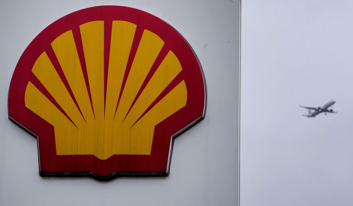An aircraft passes a sign at a Shell petrol station in London, Thursday, Feb. 2, 2023. Shell has reported that it earned nearly $5.1 billion in the second quarter. London-based oil giant Shell saw profits tumble by nearly a third in 2023 as a result of lower oil and natural gas prices, which had surged the year before in the wake of Russia&#x27;s invasion of Ukraine. (AP Photo/Kirsty Wigglesworth, File)