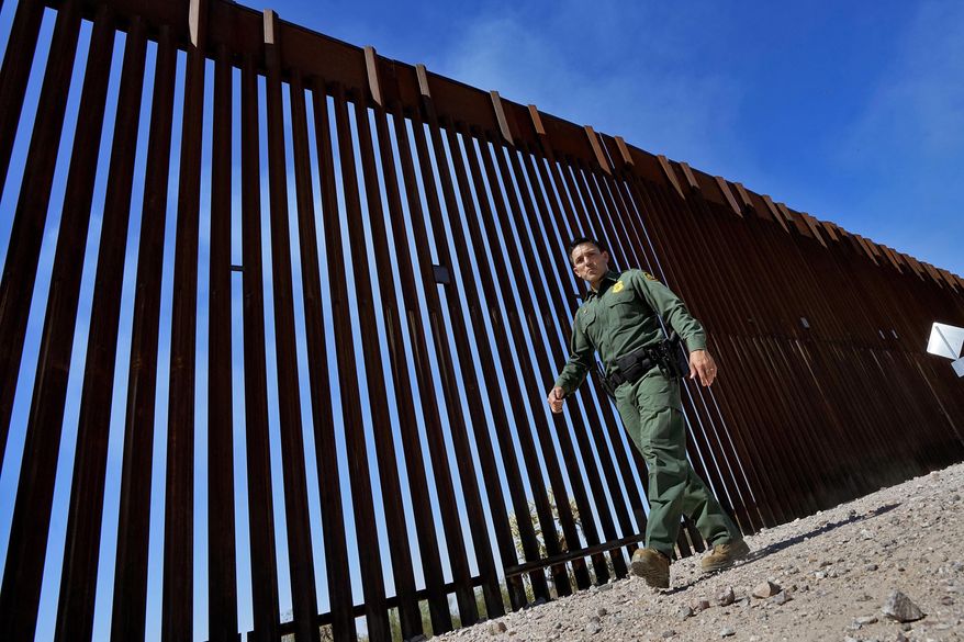 Caption: Border Patrol Deputy Chief for the Tucson Sector Justin De La Torre walks along the U.S.-Mexico border fence, on Aug. 29, 2023, in Organ Pipe Cactus National Monument near Lukeville, Ariz. Republicans are saying the open U.S. border is becoming a threat to the nation’s existence. (AP Photo/Matt York, File)